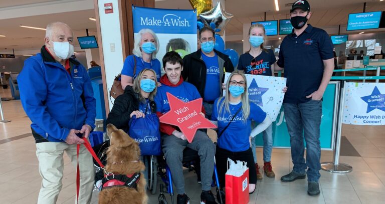 Wish kid Connor in the airport lobby with his family