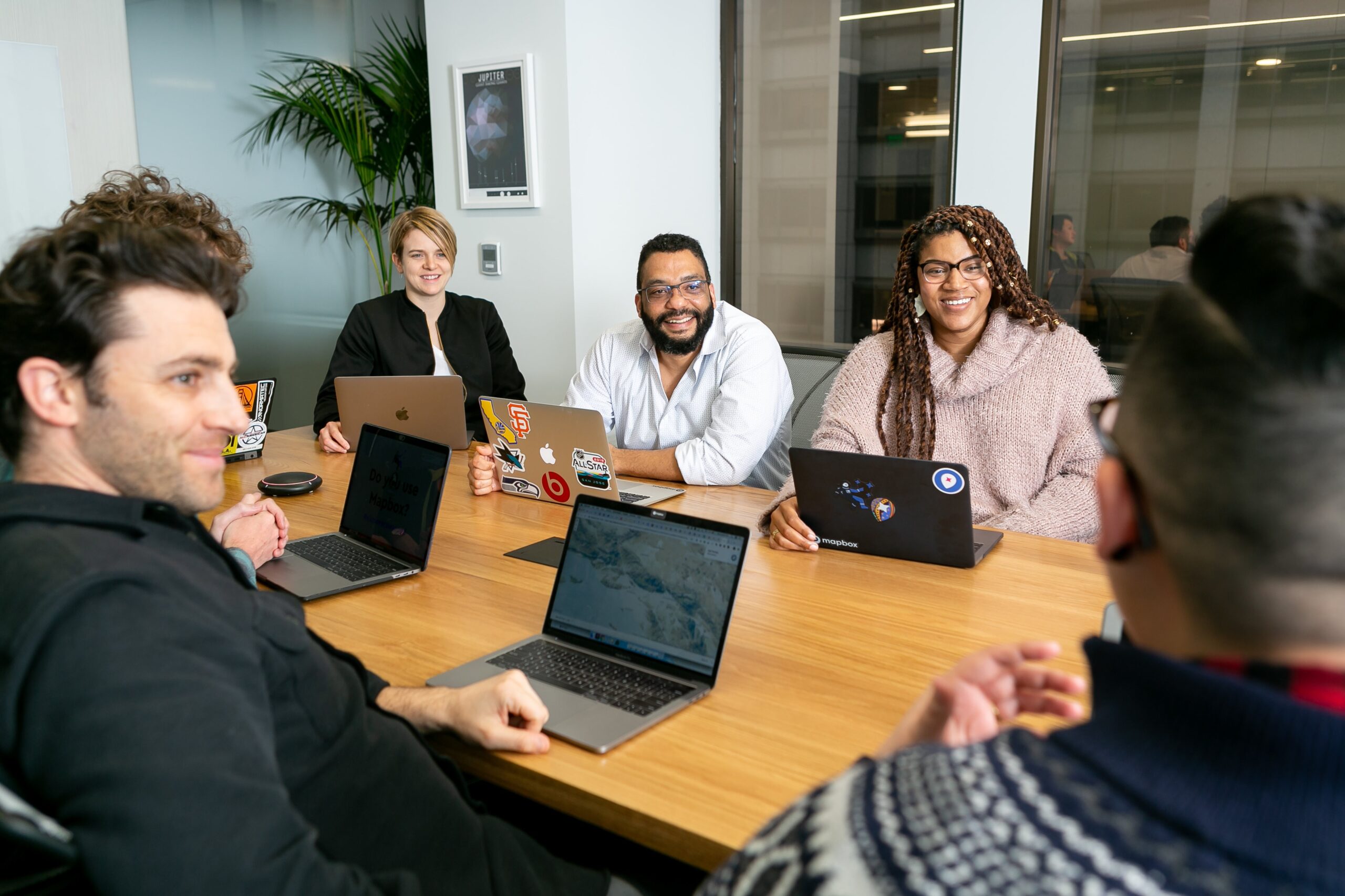 Team meeting with laptops around a desk