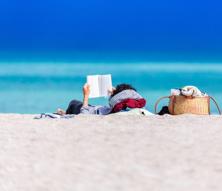 Reading a book while relaxing on the beach