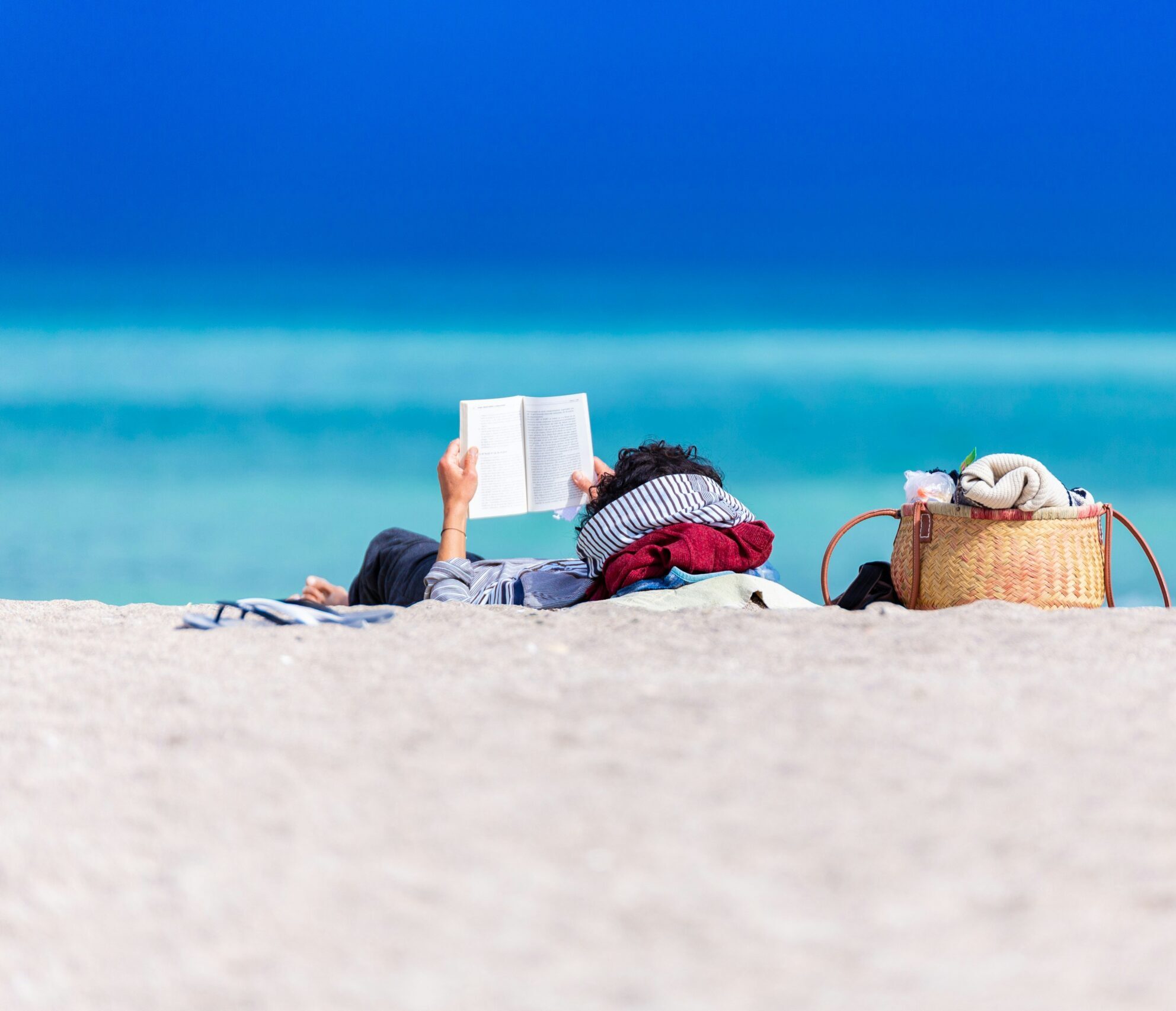 Reading a book while relaxing on the beach