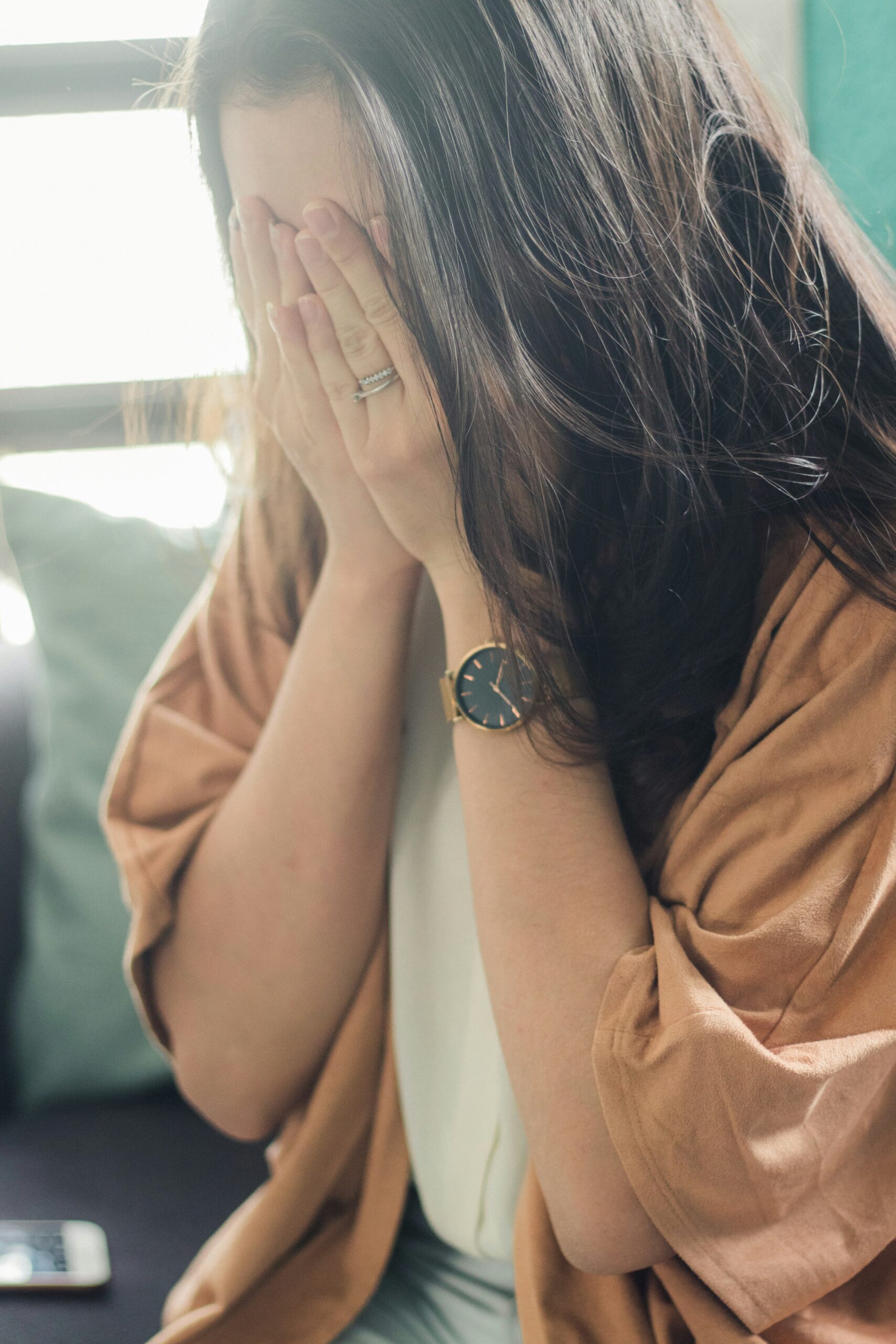 Woman with hands on face